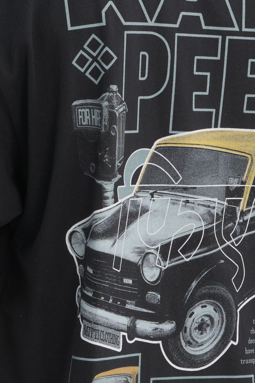 Mitti Kali Peeli Graphic Tee on model from behind, street style shot